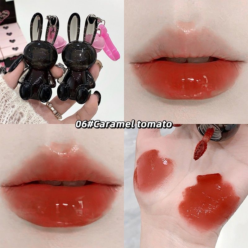 Lip gloss with rabbit-shaped applicator and color swatches on skin
