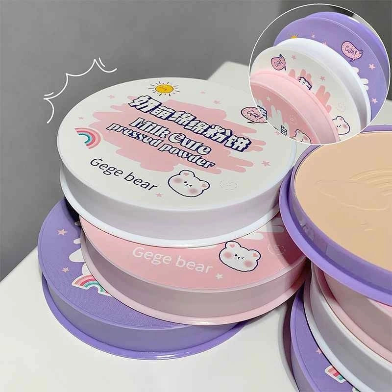 Gege Bear compact  in a hand with close-up inset showing color on skin