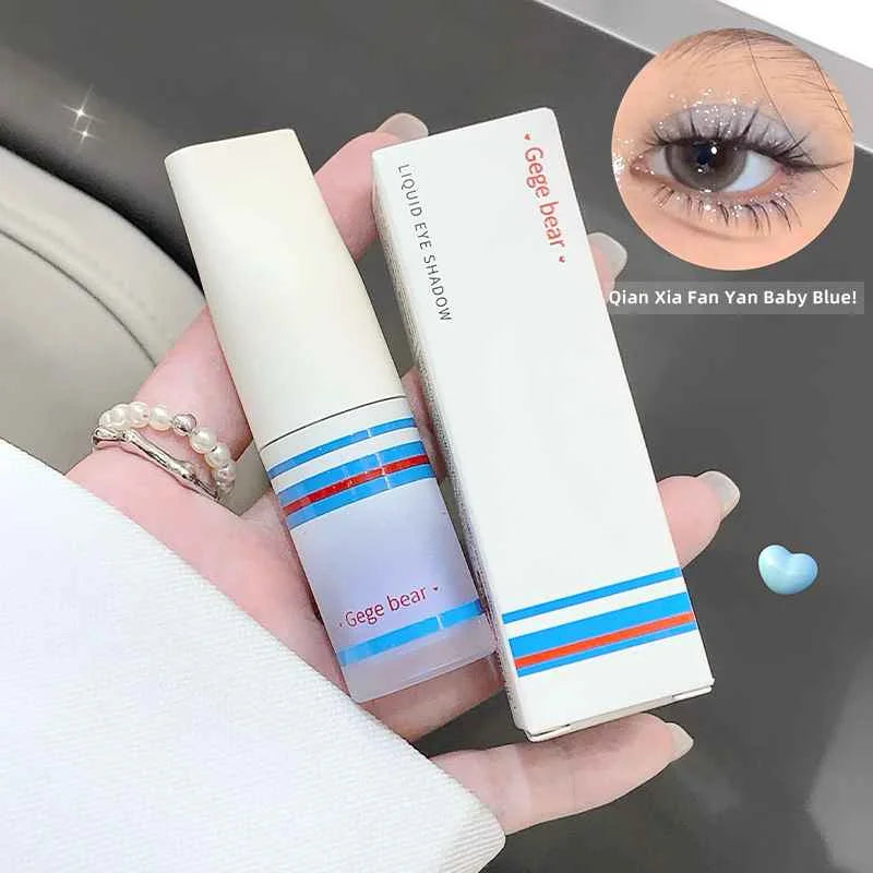 Gege bear liquid eye shadow with packaging held by a hand, close-up of applied makeup.