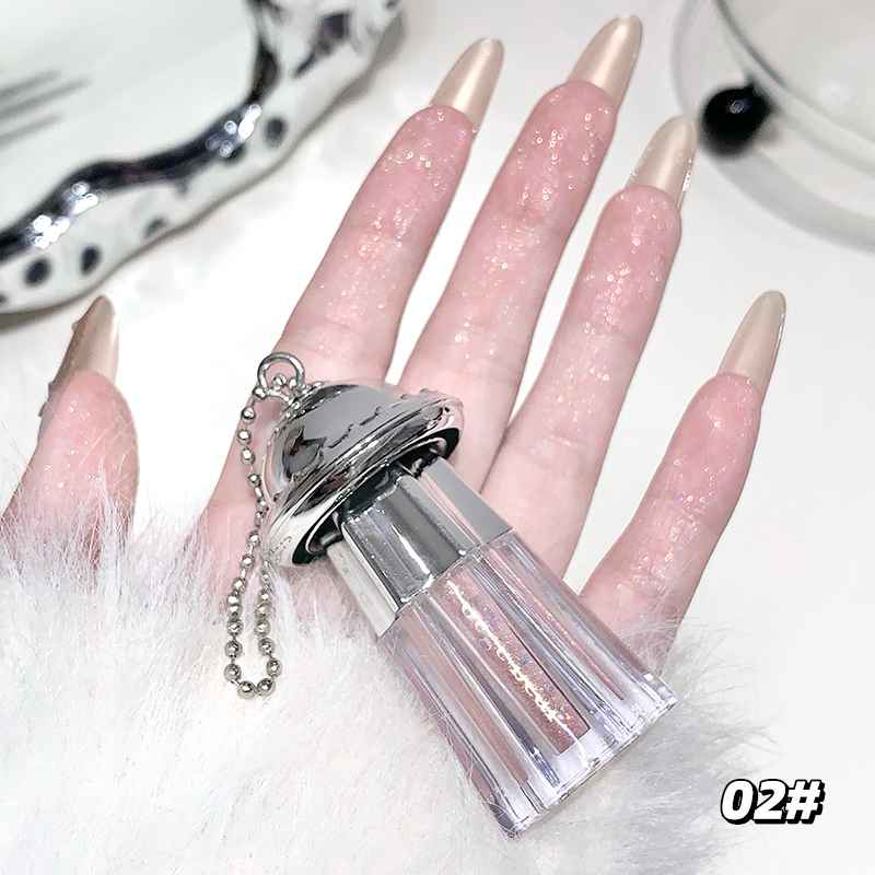 fingers showing the faint golden liqud shimmer eyeshadow and holding the container against the white background 