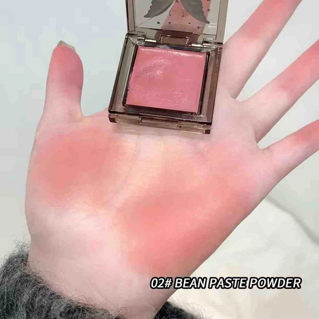 Hand holding a pink blush with '02# with shade lableling Bean Paste Powder 