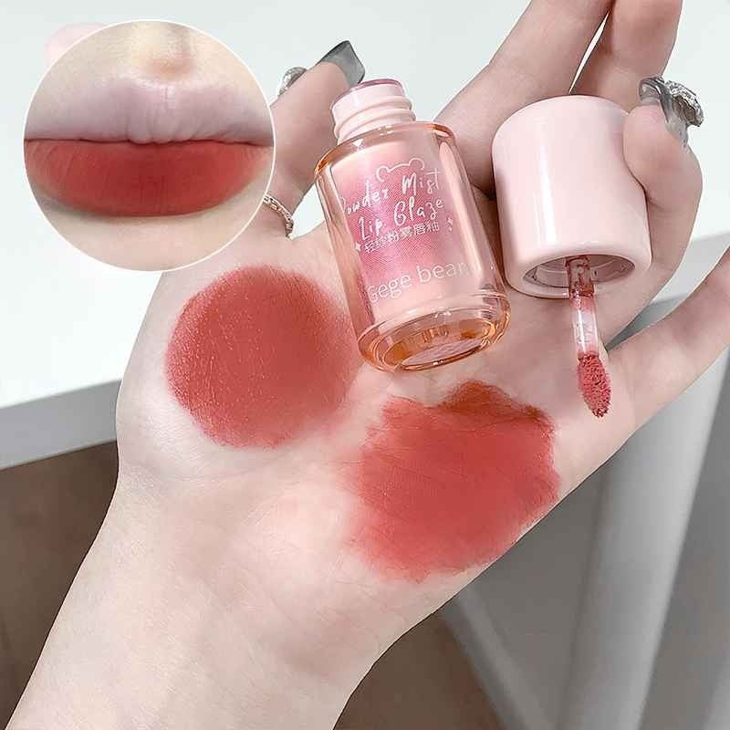 Hand with lip gloss swatches and a close-up of a lip, with a bottle labeled 'Gege Bear' on a neutral background.
