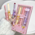 Set of colorful lip balms with a pink box on a white background
