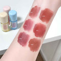Lipstick swatches on a person's arm with visible brand names.
