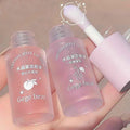 Two pink lip oil bottles with a brush on a neutral background