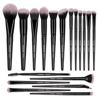 Set of makeup brushes with black handles and pink bristles on a white background