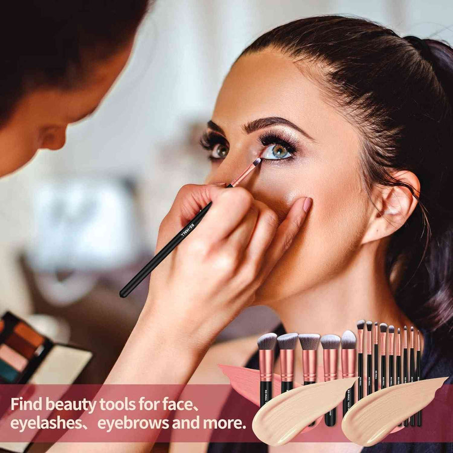 Makeup artist applying makeup to a model with a set of makeup brushes displayed.