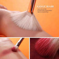 Makeup brush with goat hair, showing texture and use on skin.