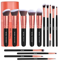 Set of makeup brushes with rose gold and black handles, including a cylindrical packaging container, on a white background.