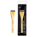Gold makeup brush with black bristles and packaging on a white background