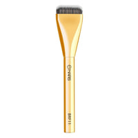 Gold makeup brush with black bristles on a white background