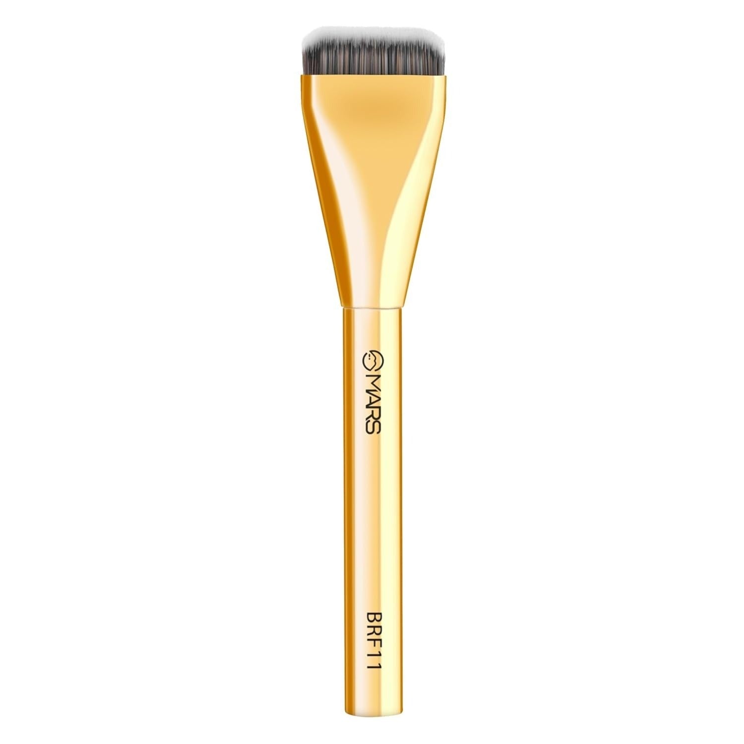 Gold makeup brush with black bristles on a white background