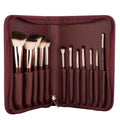 Set of makeup brushes in a brown case on a white background