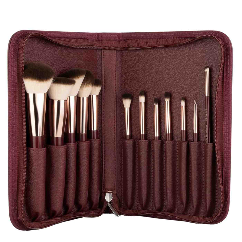 Set of makeup brushes in a brown case on a white background