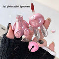 Pink rabbit-shaped lip cream with a visible brand name on a light background
