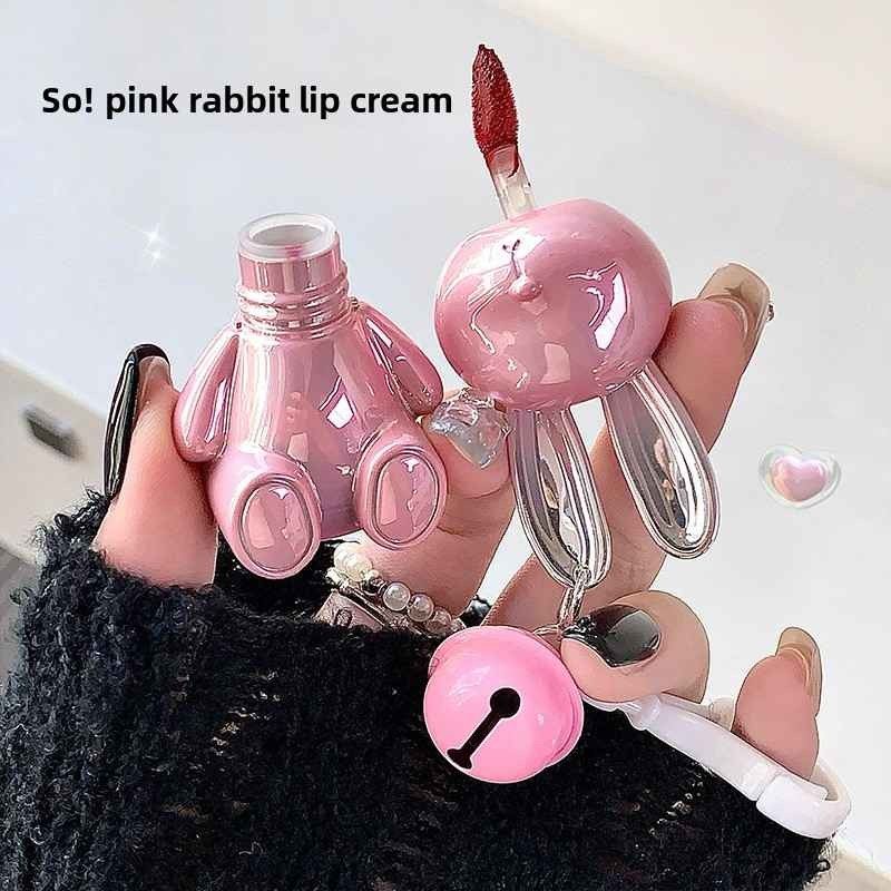 Pink rabbit-shaped lip cream with a visible brand name on a light background
