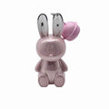 Pink rabbit-shaped lipsticks with a bell on a white background