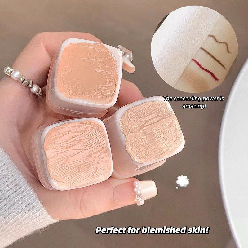 gege bear creamy concealer with a hand holding it, showing its texture and color.