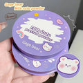 Purple compact powder case with cartoon bear design held by a hand