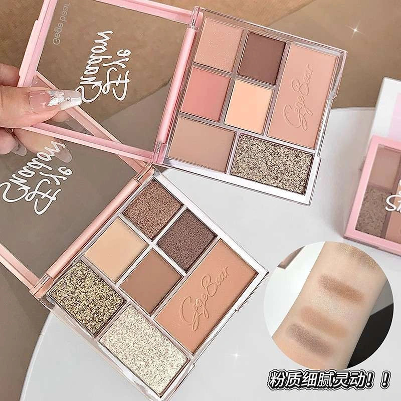 Makeup palette with various shades of eyeshadows on a white background