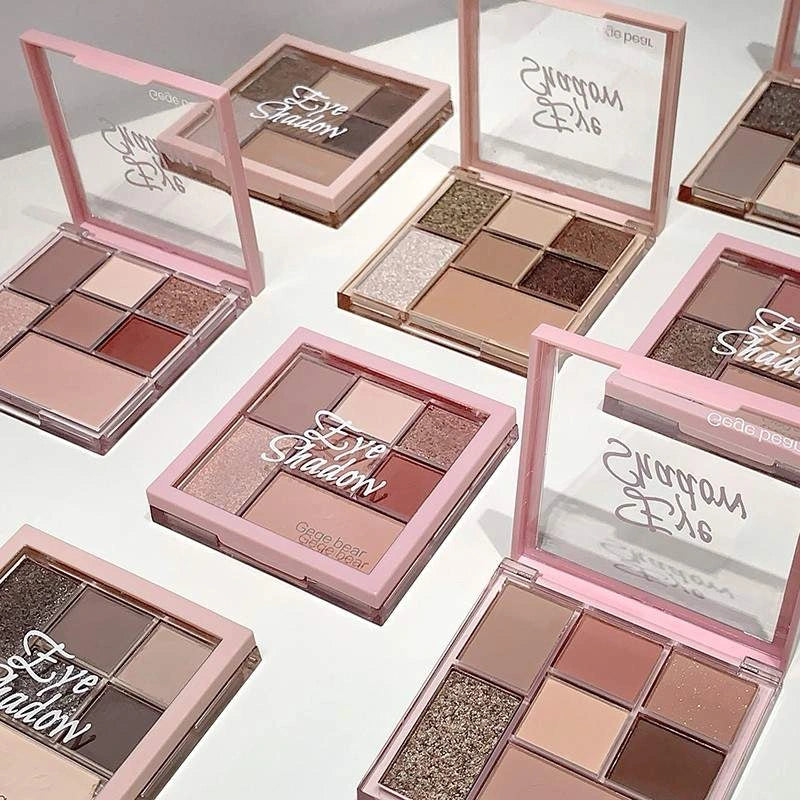 Makeup eye shadow palettes with pink cases on a white background