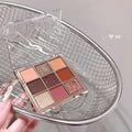 gege bear nine color glitter eyeshadow palette inside a metal mesh basket held by the hand of a lady 