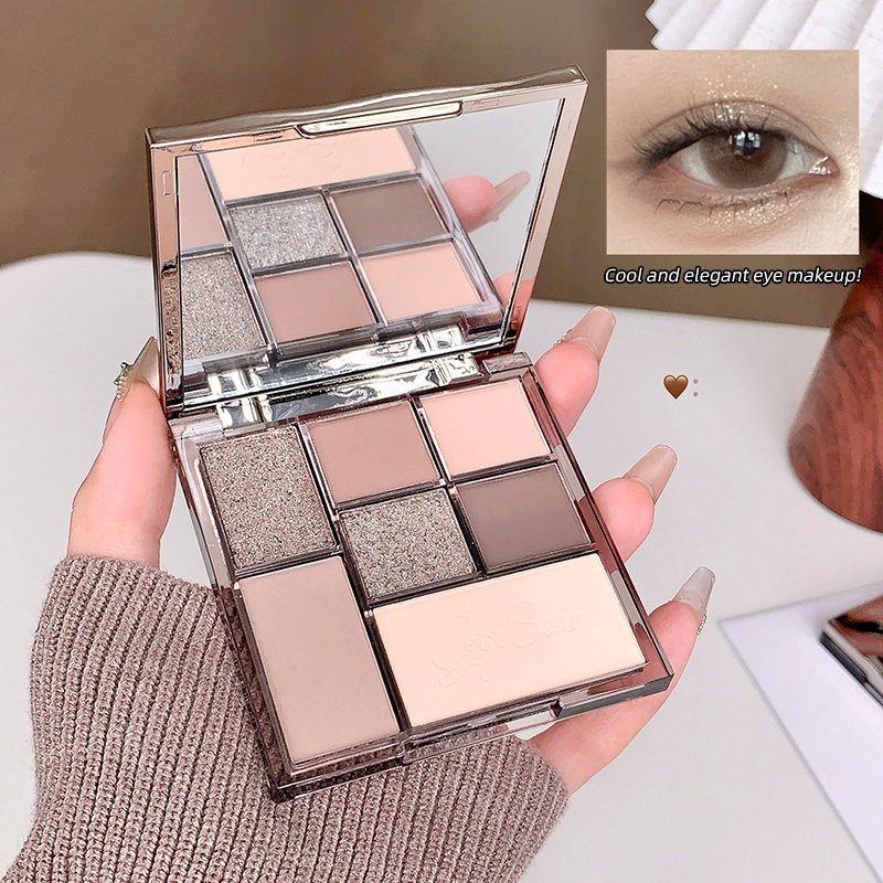 nude 7 color eyeshadow palette on the hand of a lady showing mirror and details of the swatches 