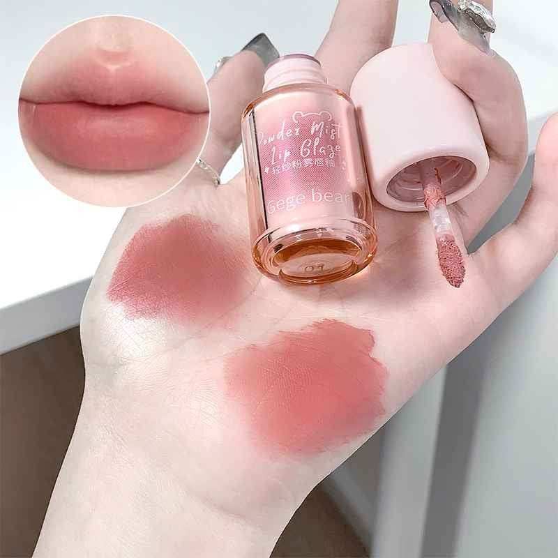 Hand holding a lip gloss with swatches on the skin and close-up of lips.