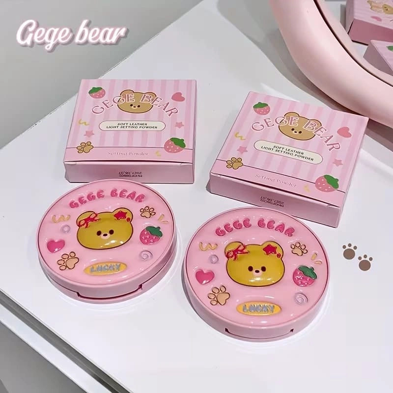 Two pink compact mirrors with a bear design and 'Gege bear' branding on a white surface.