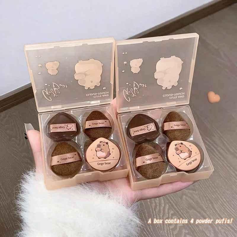 Two open boxes containing four brown beauty blender each, with cute illustrations and text gege bear on a light gray background.