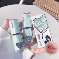 Lipstick with heart design and 'Gege bear' branding, held by a hand.