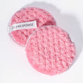 2 baby pink makeup remover pads on a white background 