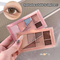 a girl holding 2 nude eyeshadow palette by the fingers and eye showing the pigmention 
