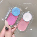 Two colorful blush palettes held by a hand with a decorative nail design.