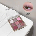 glitter eyeshaow palette in pink shade on a white table with an eye showing the details of pigmentation 