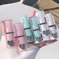 Decorative lip gloss with color swatches on a hand against a white background
