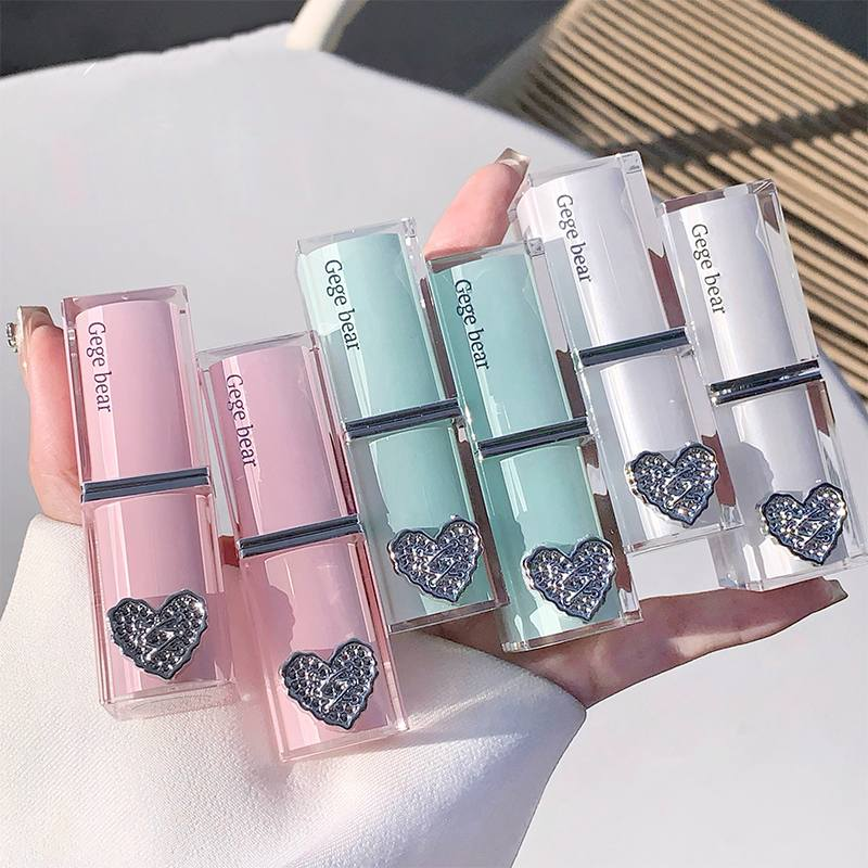 Decorative lip gloss with color swatches on a hand against a white background