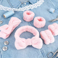 pink headbands and wristbands with props on a jeans shirt and thread in blue color 