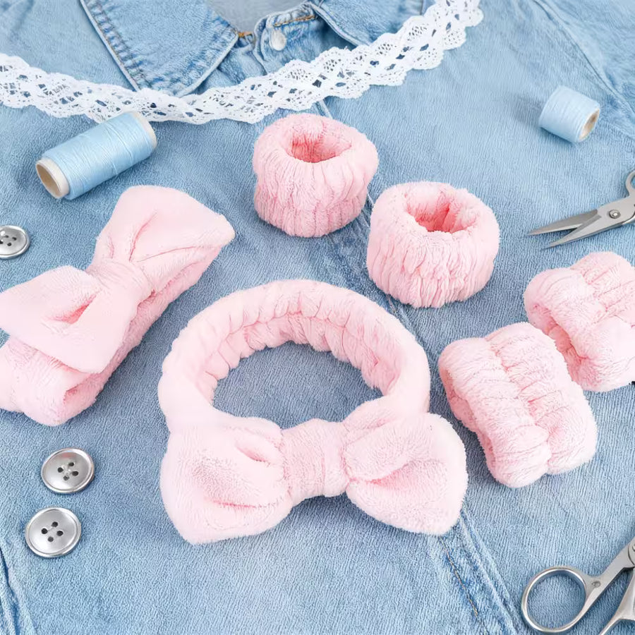 pink headbands and wristbands with props on a jeans shirt and thread in blue color 