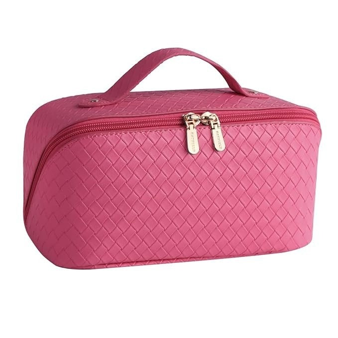 Pink quilted cosmetic bag with gold zippers on a white background