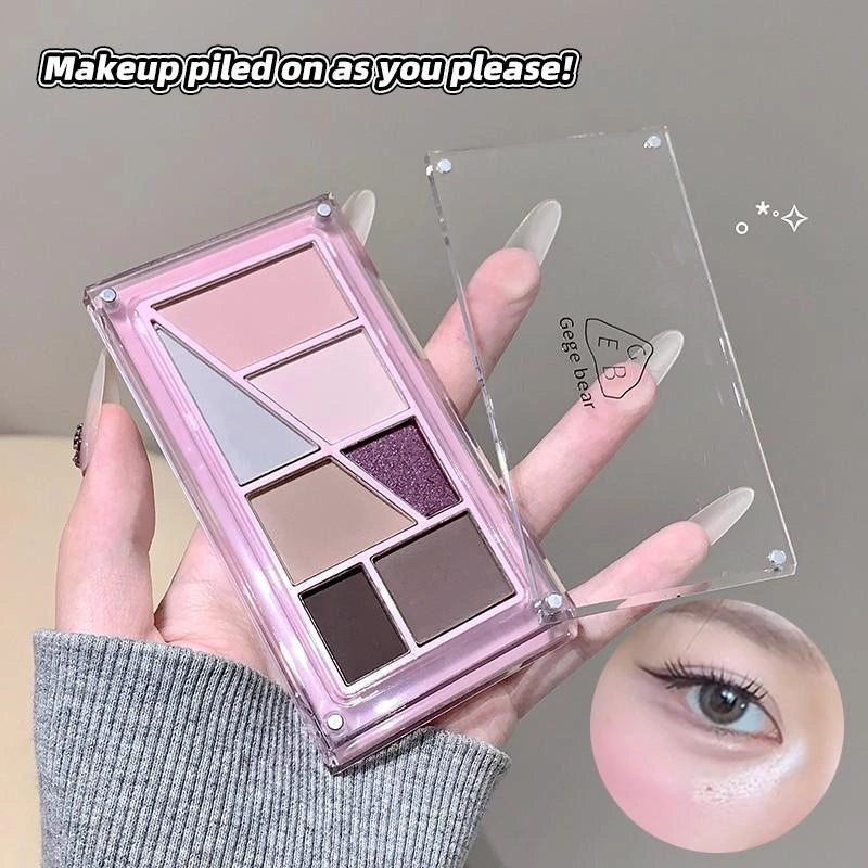 Makeup palette with eyeshadows held by a hand, with an inset of an eye wearing the makeup.