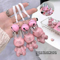 Pink bunny-shaped keychain lip stick held by a hand with a blurred background