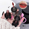 Black rabbit-shaped lip gloss held by a hand with a close-up of lips wearing the product.
