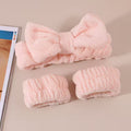 set of baby pink headband and wristbands on a grey back ground and magazine on the side 