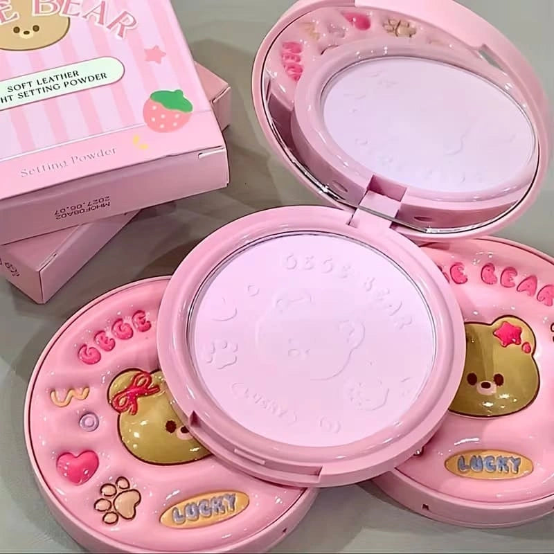 Pink compact powder with cartoon designs on a light gray background with gege bear branding on top 