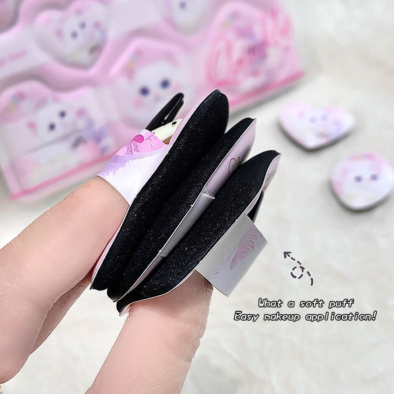 a girls finger squeezing the finger beauty blender to show the softness from the edge 