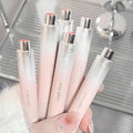 Set ofglosses held by a hand with a blurred background showing clicked based design 
