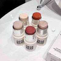 Set of gege bear Blush sticks on a white surface with a mirror in the background. Displaying pigmentations