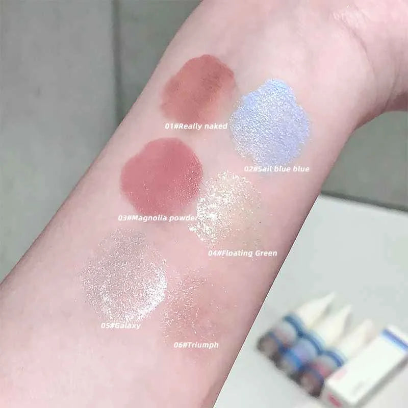 Color swatches on a person's arm with labeled makeup shades.