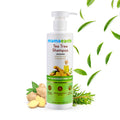 Mamaearth Tea Tree Shampoo bottle with green leaves and ginger roots on a white background
